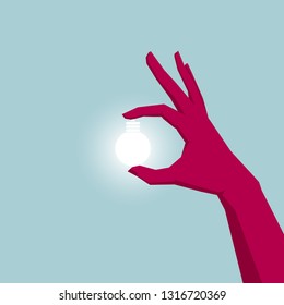 Take a light bulb in your hand. Isolated on blue background.