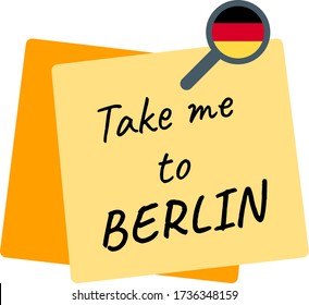 Take me to BERLIN phrase, written inside a yellow pinned paper note and with the German flag inside the pin.