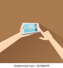 Taking Selfie Photo on Smart Phone concept on brown background. 