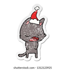 talking cat hand drawn distressed sticker cartoon of a wearing santa hat