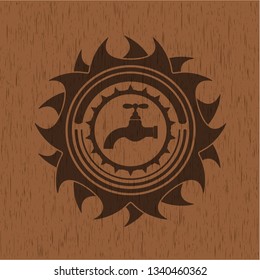 tap icon inside badge with wood background