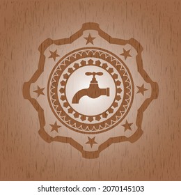 tap icon inside badge with wooden background. 