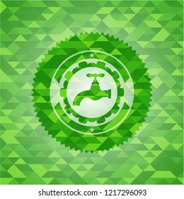 tap icon inside green emblem with triangle mosaic background