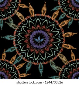 Tapestry floral abstract vector seamless mandala pattern. Ornamental colorful textured background. Decorative embroidered ethnic flowers  ornament. Repeat grunge backdrop. Embroidered patterned design