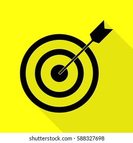 Target with dart. Black icon with flat style shadow path on yellow background.