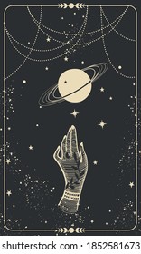 Tarot card with hand and planet. Magic card, boho design, tattoo, engraving, cover for the witch. Golden mystical hand drawing on a black background with stars