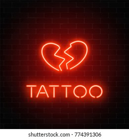 Tattoo parlor glowing neon signboard with emblem. Broken heart glowing logo on a brick wall background. Vector illustration.