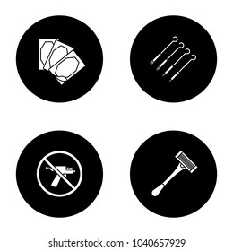 Tattoo studio glyph icons set. Piercing service. Medical plaster, tattoo needles, piercing gun prohibition, razor. Vector white silhouettes illustrations in black circles
