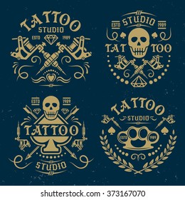 Tattoo studio or salon set of vector vintage emblems, labels, logo templates, on dark blue background with grunge texture