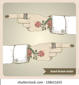 Tattooed hand and with pointing finger. Hand drawn vector illustration. 