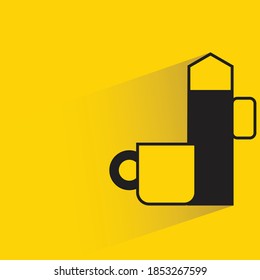 tea cup and teapot with shadow on yellow background