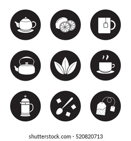 Tea icons set. Cutted lemon, steaming cup on plate, brewer, teapot, loose tea leaves, teabag, refined sugar cubes with spoon, kettle, mug. Vector white silhouettes illustrations in black circles