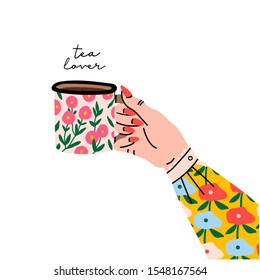 Tea lover. Female hand holding cup or mug with tea. Side view. Flower print on sleeve and cup. Hand drawn colored trendy vector illustration. Cartoon style. Flat design. Isolated on a white background