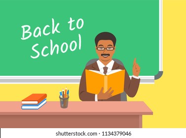 Teacher black man with open book sitting at the desk in classroom. School class interior. Traditional education concept. Vector cartoon illustration. Back to school banner