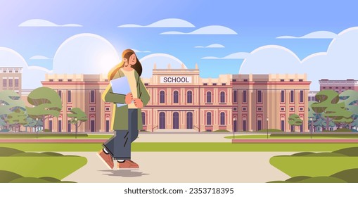 teacher with book standing near school happy labor day celebration concept horizontal