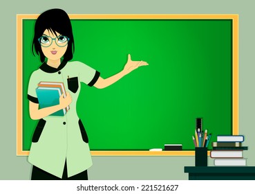 Teacher in class with a blackboard in the background.
