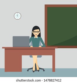 Teacher in the classroom at her desk