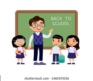 Teacher greeting pupils in classroom flat vector illustration. Boys and girls dressed in school uniform and male teacher pointing at blackboard cartoon characters. Primary students back to school