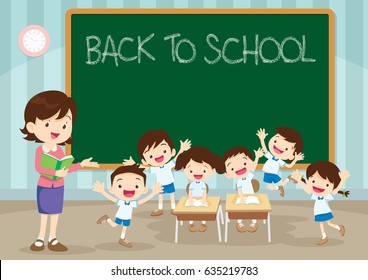 Teacher and pupils happy at desk together at the elementary school. Back to school kids,education concept