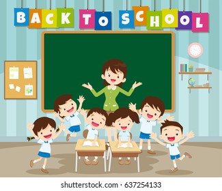 Teacher and pupils happy at desk together at the elementary school,back to school kids,education concept