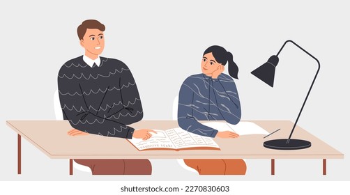 Profesora y estudiante sentados juntos en la mesa en clase