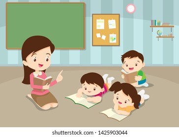 Teacher teaching Cute Childrens Reading Books. in classroom teacher and children reading book in the kindergarten.