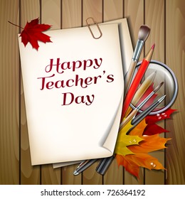 Teachers Day vector card. Paper sheet with lettering Happy Teachers Day with autumn leaves, pens, pencils, brushes and magnifying glass on wooden background texture.
