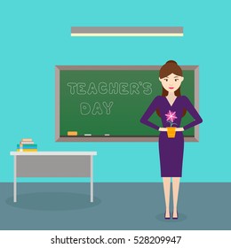 Teacher's Day. Young womens teacher with a flower in her hand in class. Vector illustration. Flat design.