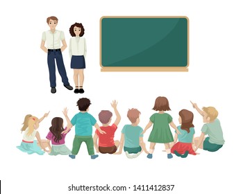 The teachers explain the new lesson, the beginning of the school year, the children sit on the floor, the activity in the kindergarten lesson, raise their hands up and show ahead. Back view.