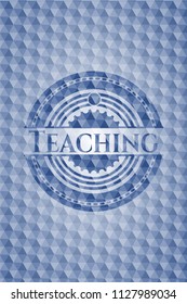 Teaching blue badge with geometric background.