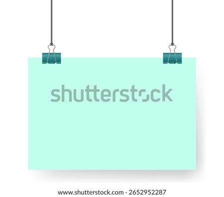 Teal green sheet of paper, note hanging on binder clip. A4 format. Album orientation	