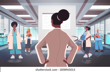 team of mix race doctors in uniform discussing during meeting in hospital corridor medicine healthcare concept horizontal full length vector illustration