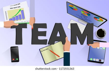 Team work concept. Top view on hands with letters TEAM above desk with laptop,mobile, tablet and other business accessories Modern business workplace