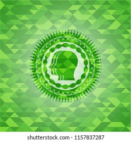 team work icon inside green emblem with mosaic ecological style background