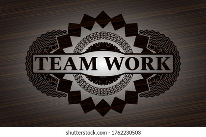 Team Work text inside wooden emblem. Brown handsome background. Vector illustration. 