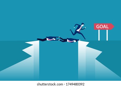 Team work vector concept: Businessmen lying and hanging over the cliff while another businessman crossing to reach the goal