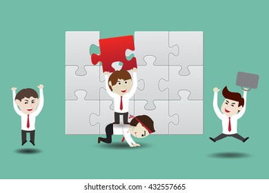 Teamwork, businessman assembling pieces of a puzzle