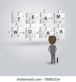 Teamwork concept of businessman looking to the jigsaw puzzle