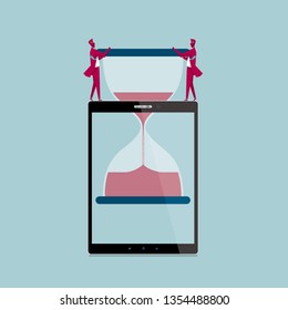 Teamwork concept. Two businessmen stuffed the hourglass into the tablet. Isolated on blue background.