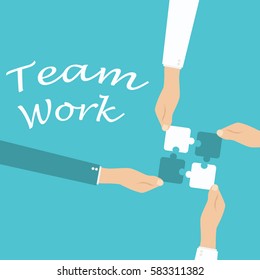 Teamwork and cooperation concept. Hands holding and putting puzzle pieces together.