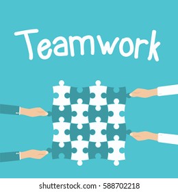Teamwork and cooperation concept. Hands holding and putting puzzle pieces together.