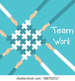 Teamwork and cooperation concept. Hands holding and putting puzzle pieces together.