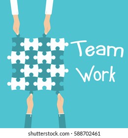 Teamwork and cooperation concept. Hands holding and putting puzzle pieces together.