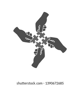 Teamwork And Cooperation Icon Or Logo Concept. Hands Holding And Putting Puzzle Pieces Together