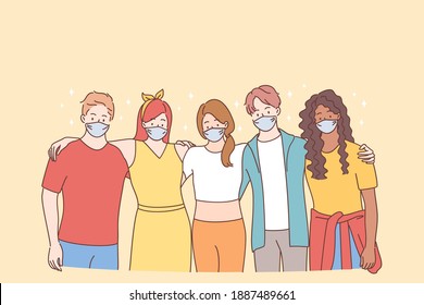 Teamwork, support, multiracial group concept. Young people mixed race friends in protective face masks or creative colleagues standing and hugging each other during pandemic times 