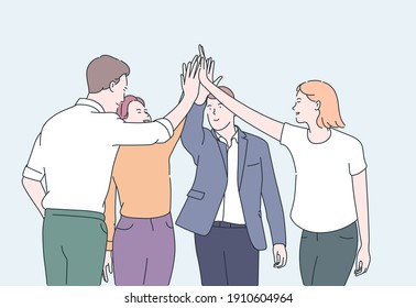 Teamwork and team building concept. Young business people office workers partners standing and giving hands after successful negotiations.