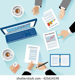 Teamwork. View desktop on top. Hands of people. Computer, business papers, and cards. Sheets with graphics. Creative Team Concert.