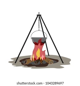 The teapot hangs on the tripod. Below is a fire burning.