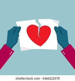 Tearing the heart symbol using both hands. Isolated on blue background.	