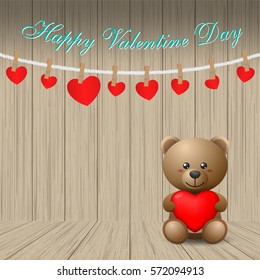 Teddy bear holding a heart-shaped pillow